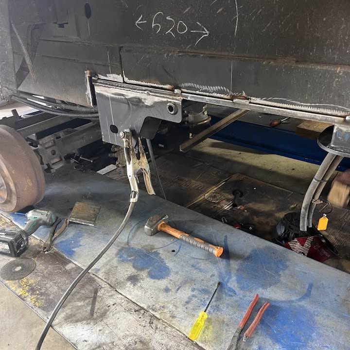 The underside of a caravan chassis with a new suspension hanger fitted