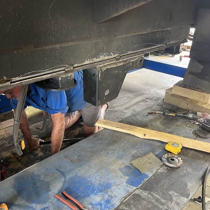 Working underneath a caravan chassis on the hoist