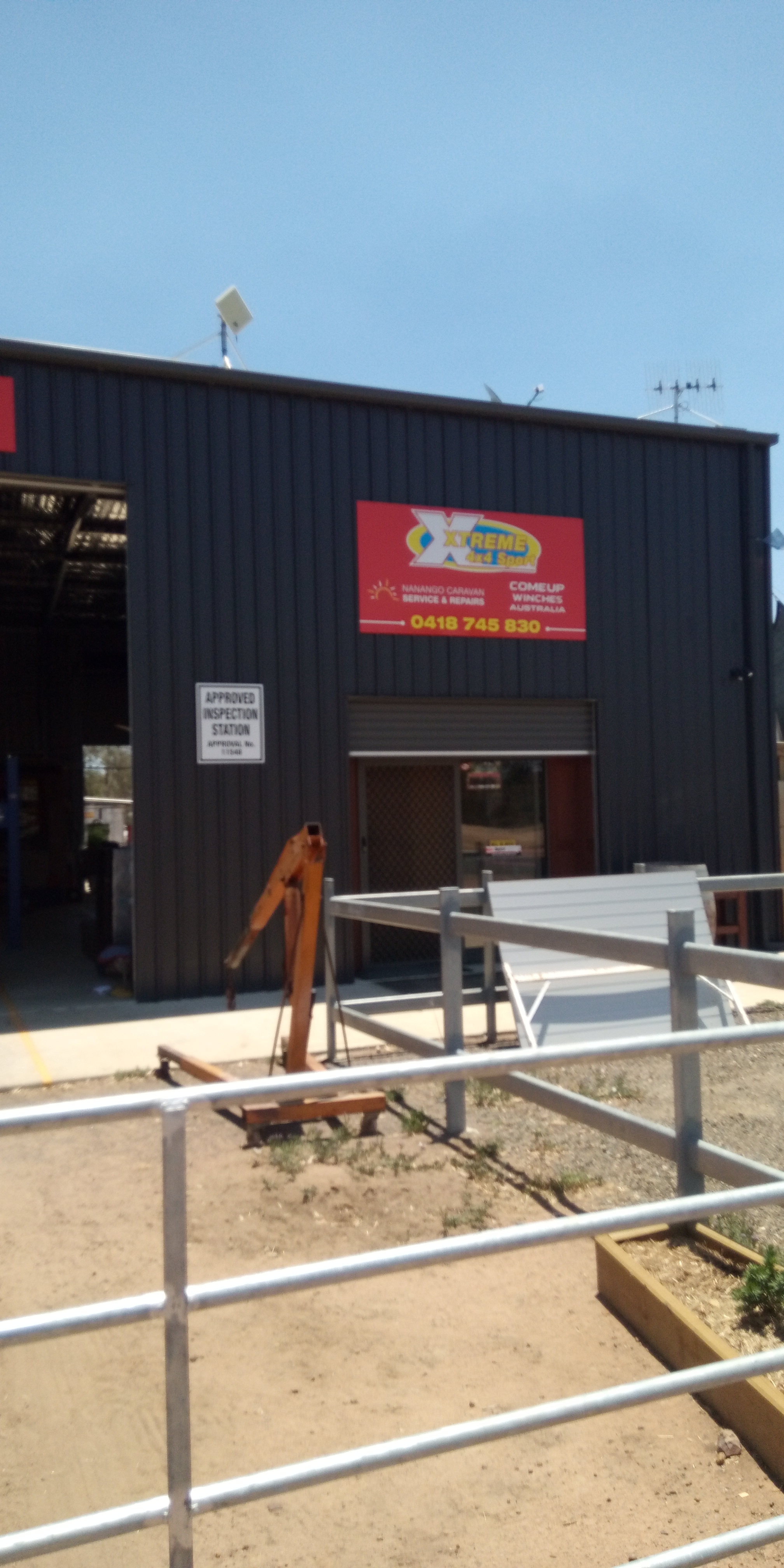 The Nanango Caravan Service and Repairs workshop on Knowles Street, with its red sign and Approved Inspection Station notice